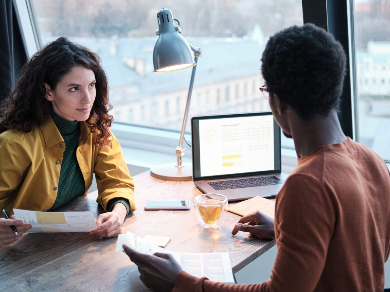 Business colleagues planning work together they working with documents and using laptop at office