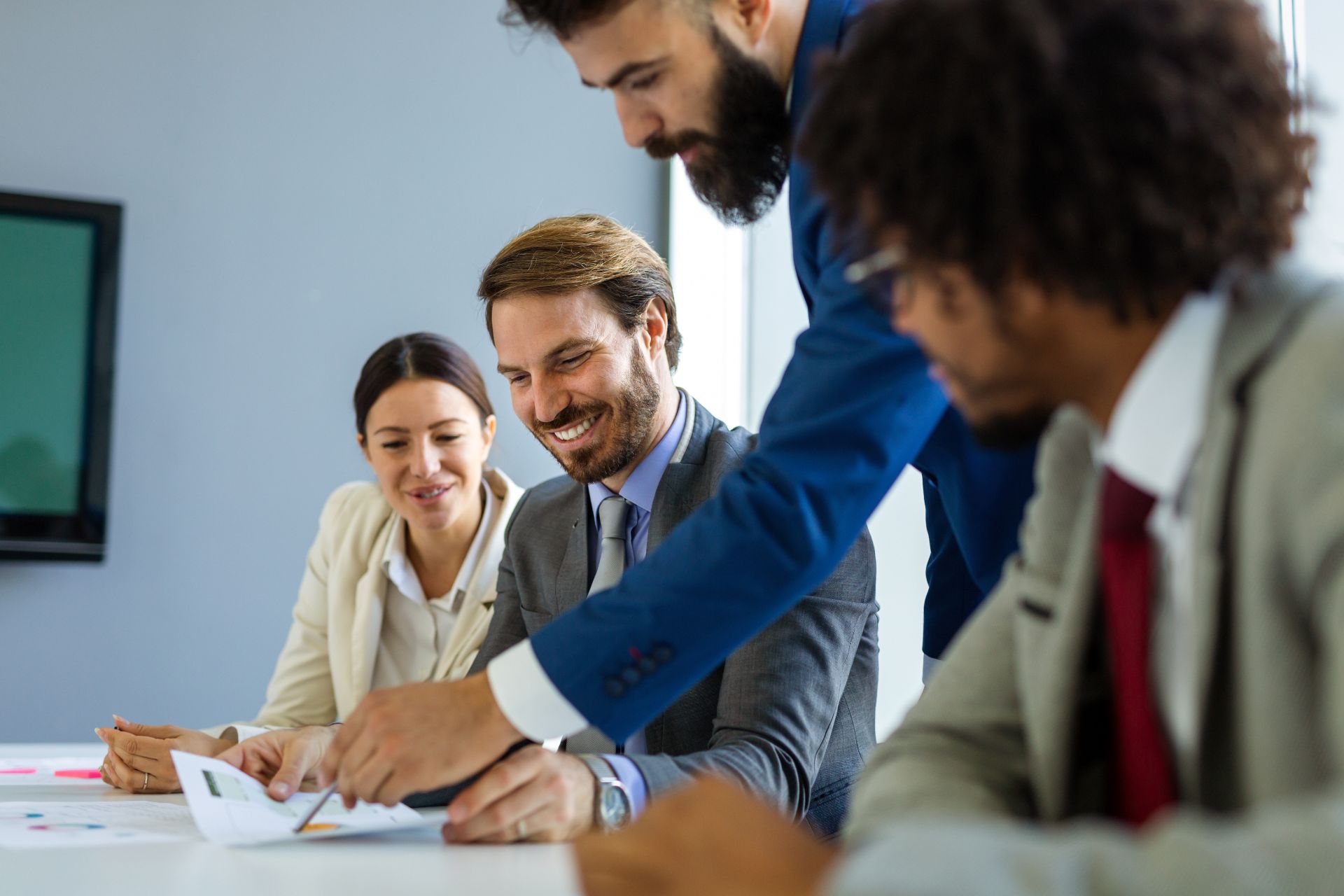 Happy boss talking to a happy team.