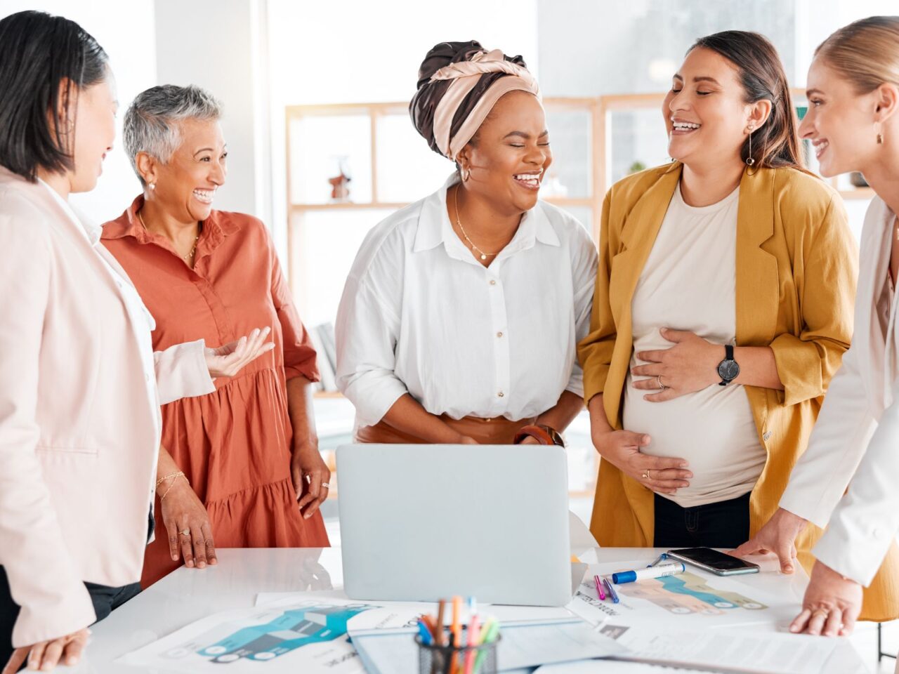 Five laughing business women